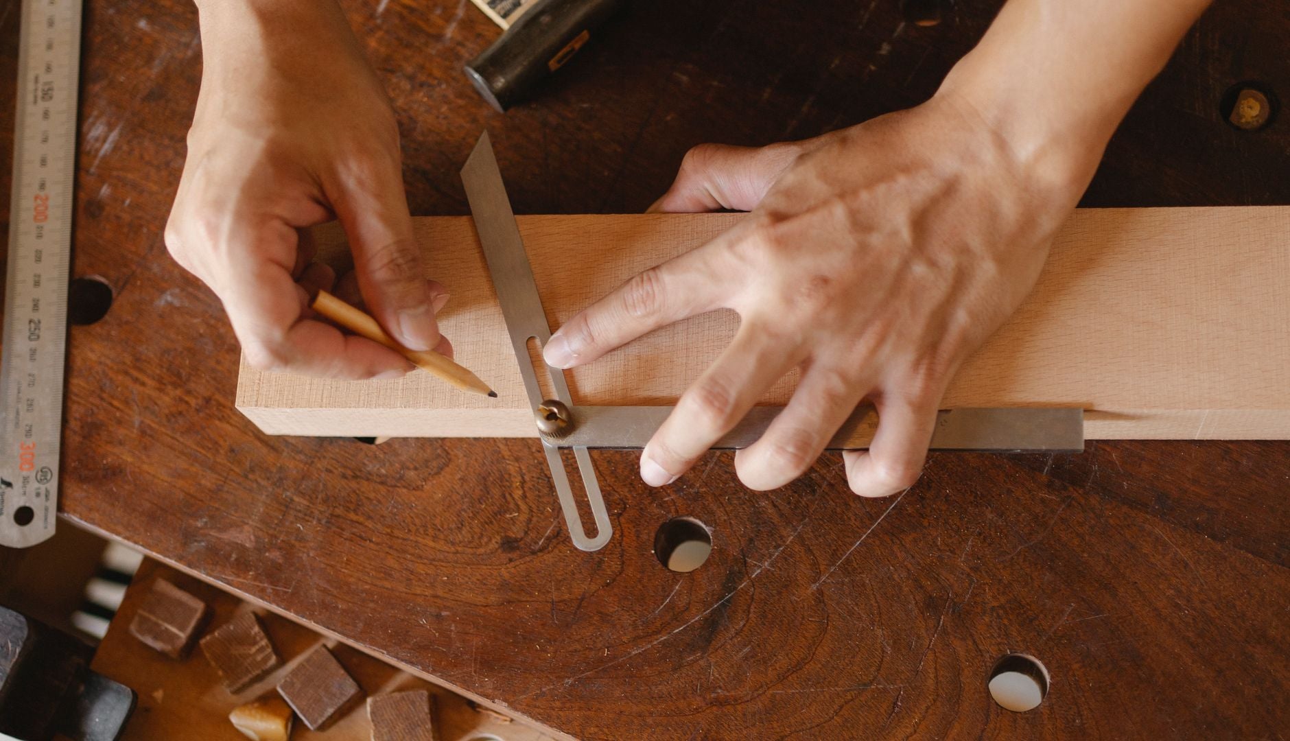 Craftsman shaping a walnut tabletop in a sunlit workshop